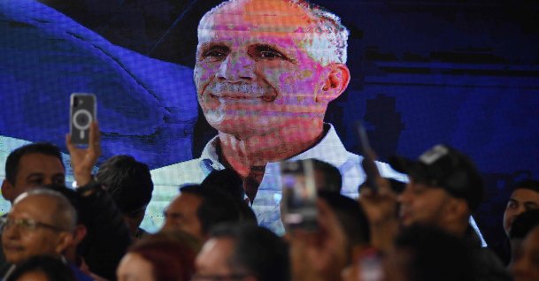 An LCD screen displays a portrait of Honduras presidential candidate Nasry Asfura of the National Party, as supporters celebrate after the National Electoral Council (CNE) declares him the winner of the Honduras Presidential Election in Tegucigalpa, Honduras, Dec. 24, 2025. (AFP Photo)