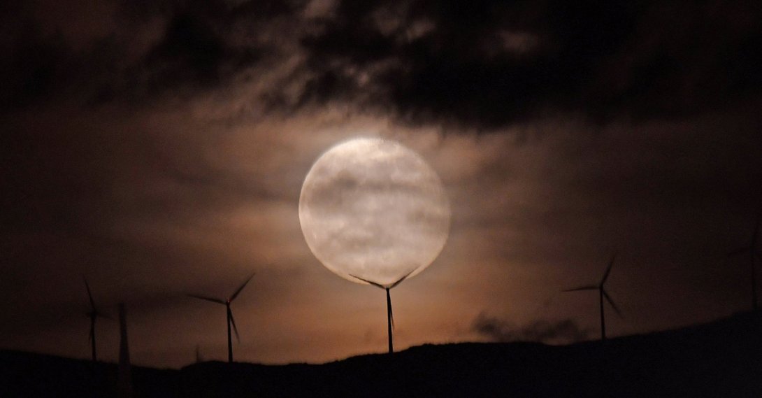 The full moon rises over a wind turbine in Nafplion, Peloponnese region, Greece, Dec. 6, 2025. (EPA Photo)
