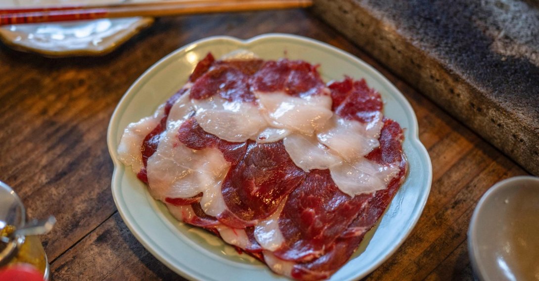 In this picture, slices of bear meat are served on a plate at a restaurant in Chichibu, Saitama Prefecture, Japan, Dec. 12, 2025. (AFP Photo)