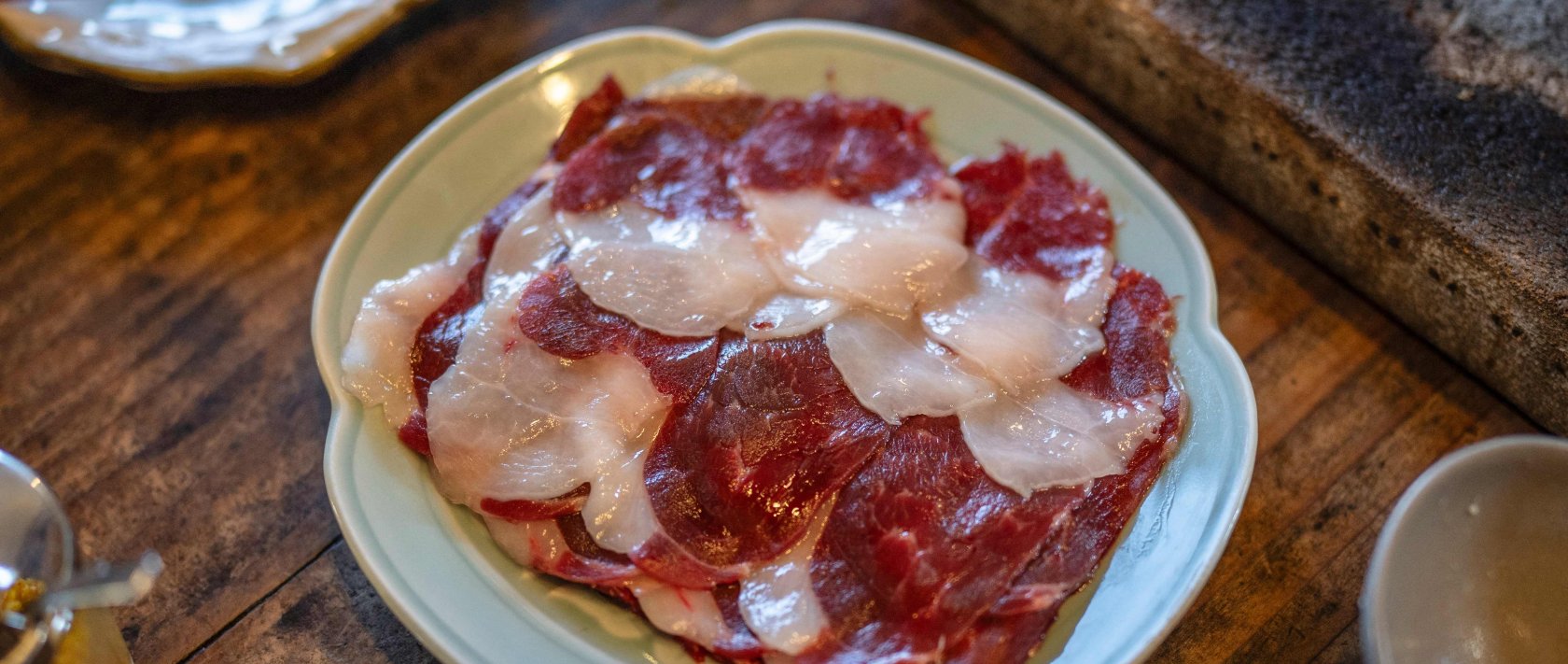 In this picture, slices of bear meat are served on a plate at a restaurant in Chichibu, Saitama Prefecture, Japan, Dec. 12, 2025. (AFP Photo)
