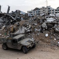 An Israeli soldier walks past a military vehicle and rubble in Rafah in the southern Gaza Strip, Dec. 8, 2025. (Reuters Photo)