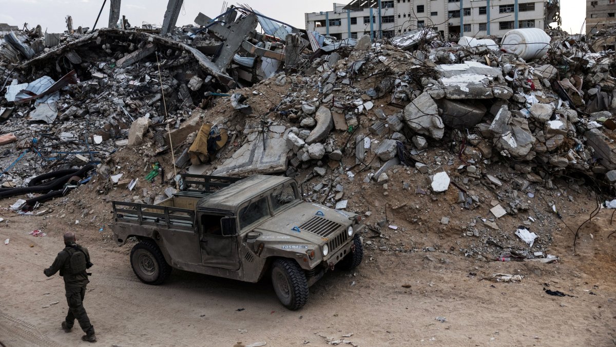 An Israeli soldier walks past a military vehicle and rubble in Rafah in the southern Gaza Strip, Dec. 8, 2025. (Reuters Photo)