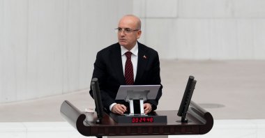 Treasury and Finance Minister Mehmet Şimşek speaks in front of Parliament, Ankara, Türkiye, Dec. 15, 2025. (AA Photo)