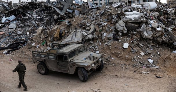 An Israeli soldier walks past a military vehicle and rubble in Rafah in the southern Gaza Strip, Dec. 8, 2025. (Reuters Photo)