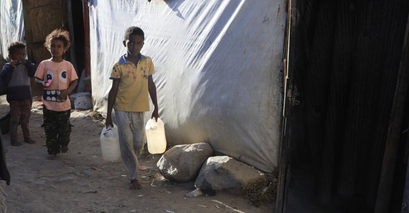 A displaced Yemeni boy holds bottles of water at a makeshift camp for Internally Displaced Persons (IDPs) in Sana'a, Yemen, Dec. 24, 2025. (EPA Photo)