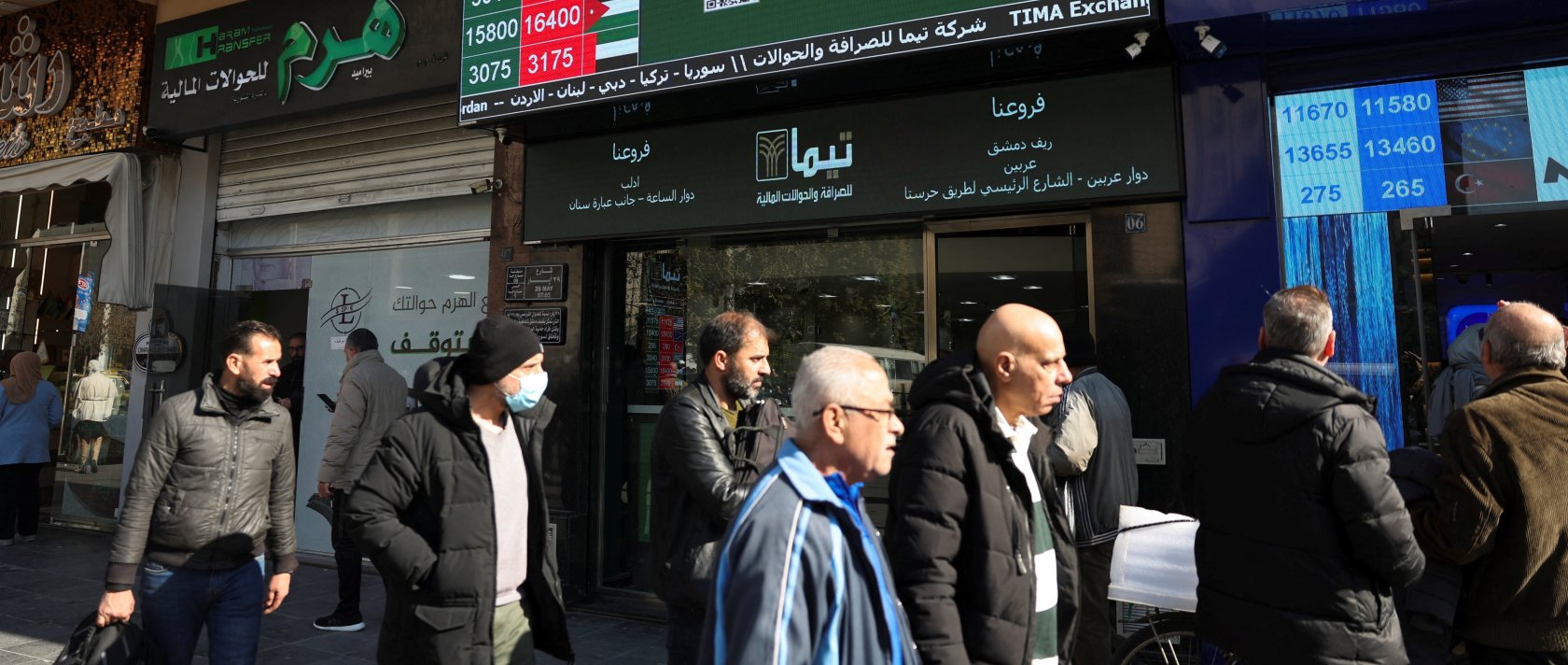 People pass by a currency exchange and money transfer shop in Damascus, Syria, Dec. 18, 2025. (Reuters Photo)