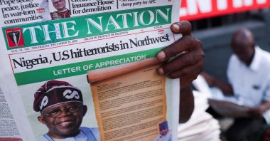 People read newspapers reporting on U.S. airstrikes against Daesh members, Lagos, Nigeria, Dec. 26, 2025. (Reuters Photo)
