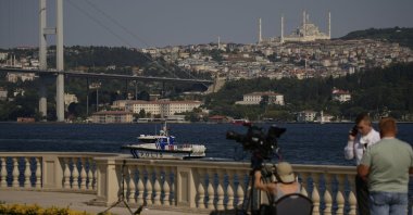 A police boat patrols the Bosporus as journalists work at Çırağan Palace ahead of expected talks between Russian and Ukrainian delegations, Istanbul, Türkiye, July 23, 2025. (AP Photo)
