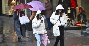 People walk during a rainy day, Ankara, Türkiye, Dec. 23, 2025. (AA Photo)