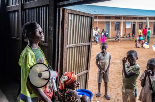 A young refugee from stands with a megaphone to give instructions to other refugees at a food distribution point at Nyarushishi Transit Camp, Rusizi district, DRC, Dec. 11, 2025. (AFP Photo)