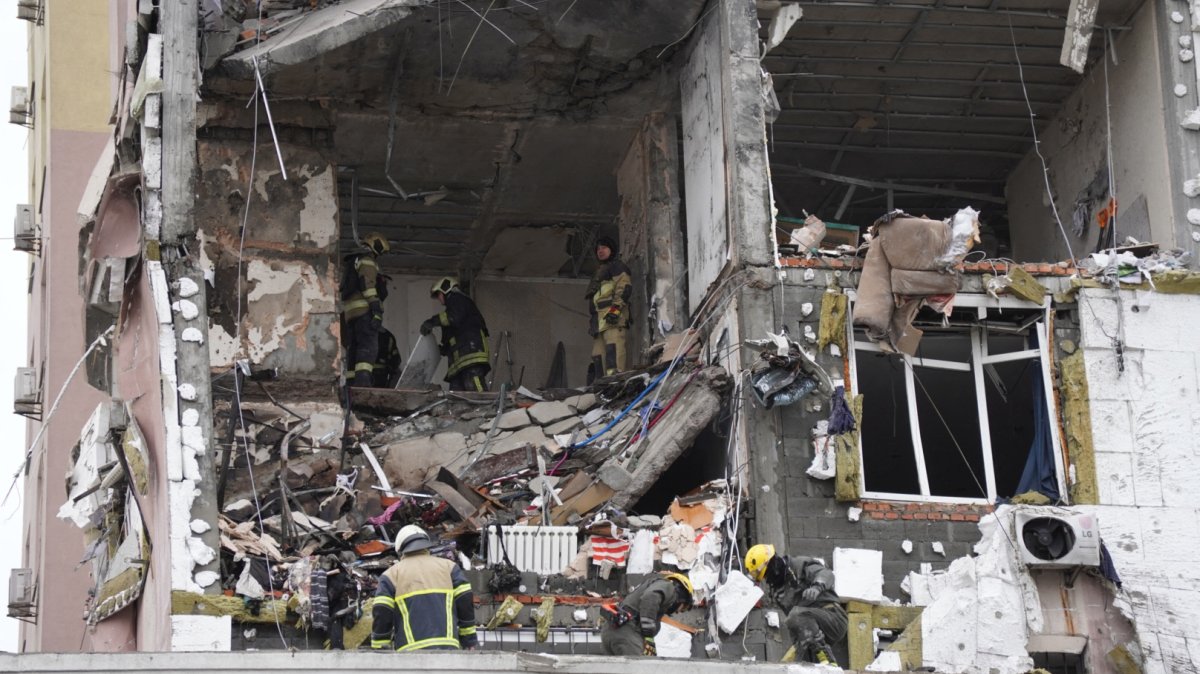 Ukrainian rescuers look through rubble inside a damaged residential building following Russian drones and missiles attack, in Kyiv, Ukraine, Dec. 27, 2025. (AFP Photo)