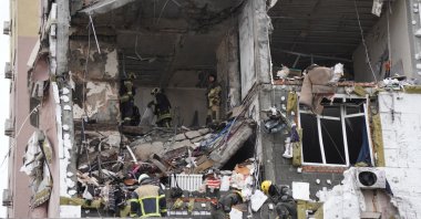 Ukrainian rescuers look through rubble inside a damaged residential building following Russian drones and missiles attack, in Kyiv, Ukraine, Dec. 27, 2025. (AFP Photo)