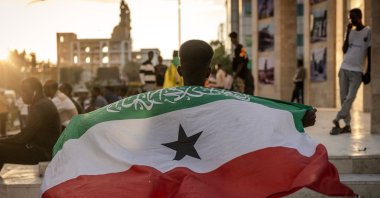 A man holds a flag of Somaliland in front of the Hargeisa War Memorial monument in Hargeisa, Nov. 7, 2024. (AFP Photo)