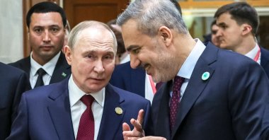Russia's President Vladimir Putin talks to Türkiye’s Foreign Minister Hakan Fidan in Ashgabat, Turkmenistan, Dec. 12, 2025. (AFP Photo)