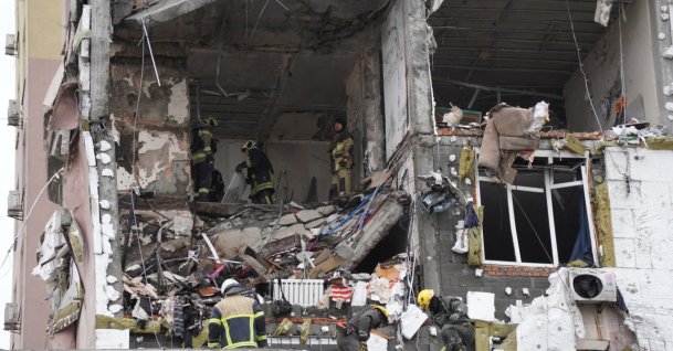 Ukrainian rescuers look through rubble inside a damaged residential building following Russian drones and missiles attack, in Kyiv, Ukraine, Dec. 27, 2025. (AFP Photo)