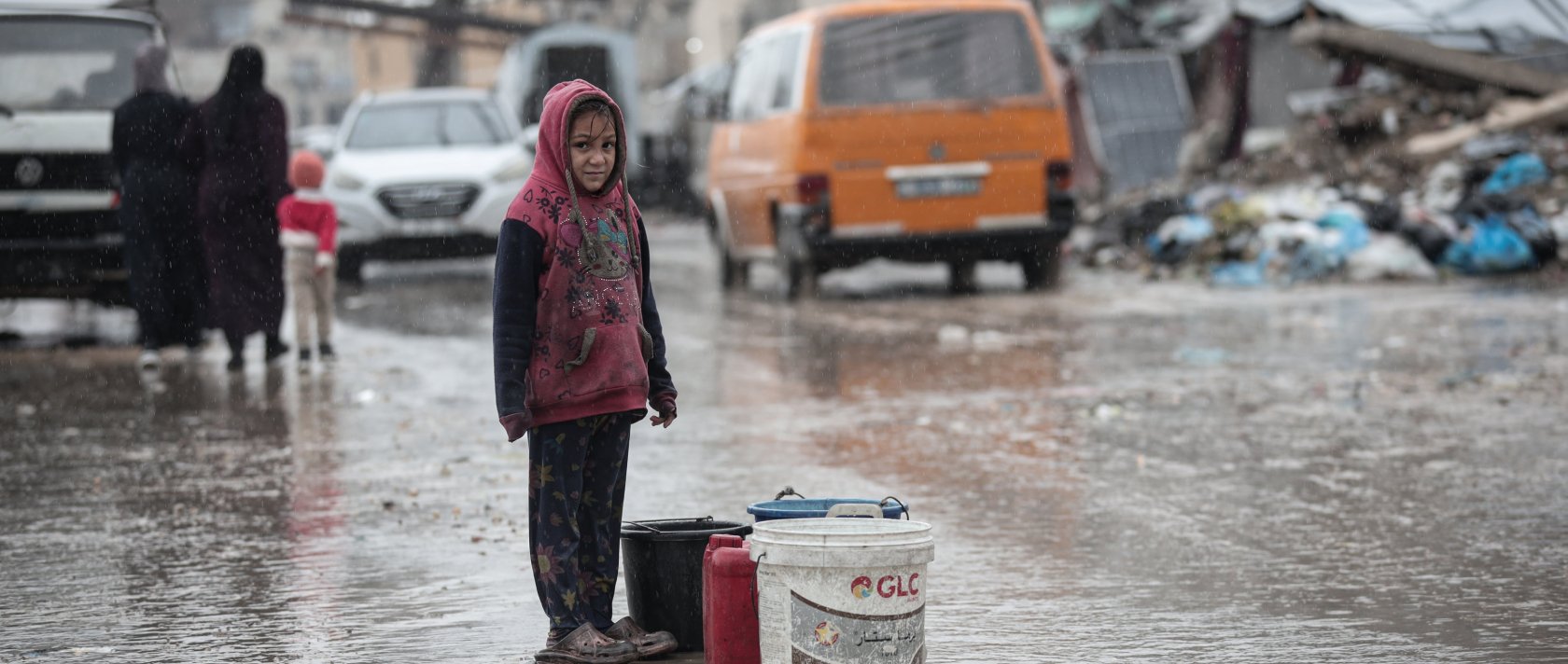 A displaced Palestinian child looks on amid a rainstorm in the western Gaza Strip, Dec. 27, 2025. (AA Photo)