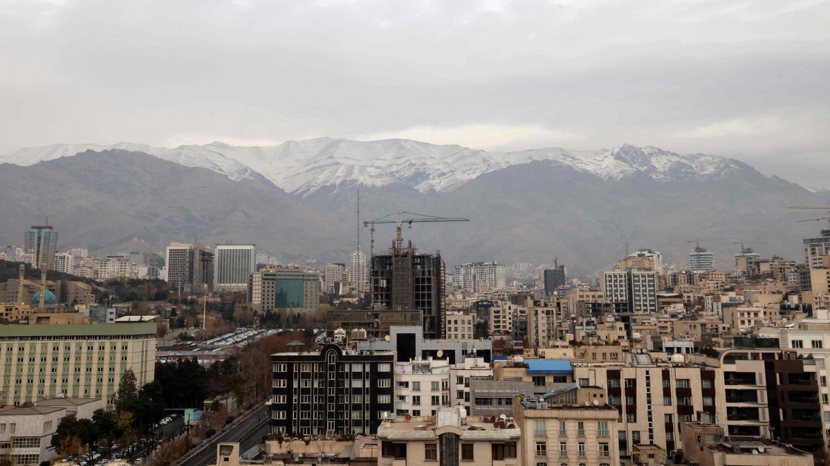A general view shows the Iranian capital Tehran with the snow-covered Alborz mountain range in the background, Dec. 9, 2025 (AFP Photo)