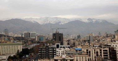 A general view shows the Iranian capital Tehran with the snow-covered Alborz mountain range in the background, Dec. 9, 2025 (AFP Photo)