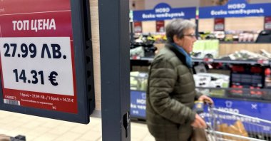 A woman shops inside a Lidl store, as prices are displayed in both the Bulgarian lev and euro currencies, Sofia, Bulgaria, Dec. 18, 2025. (Reuters Photo)