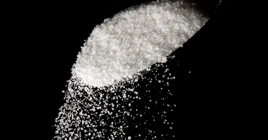 This photo illustration shows granulated sugar falling from a spoon, Philadelphia, U.S., Sept. 12, 2016. (AP Photo)