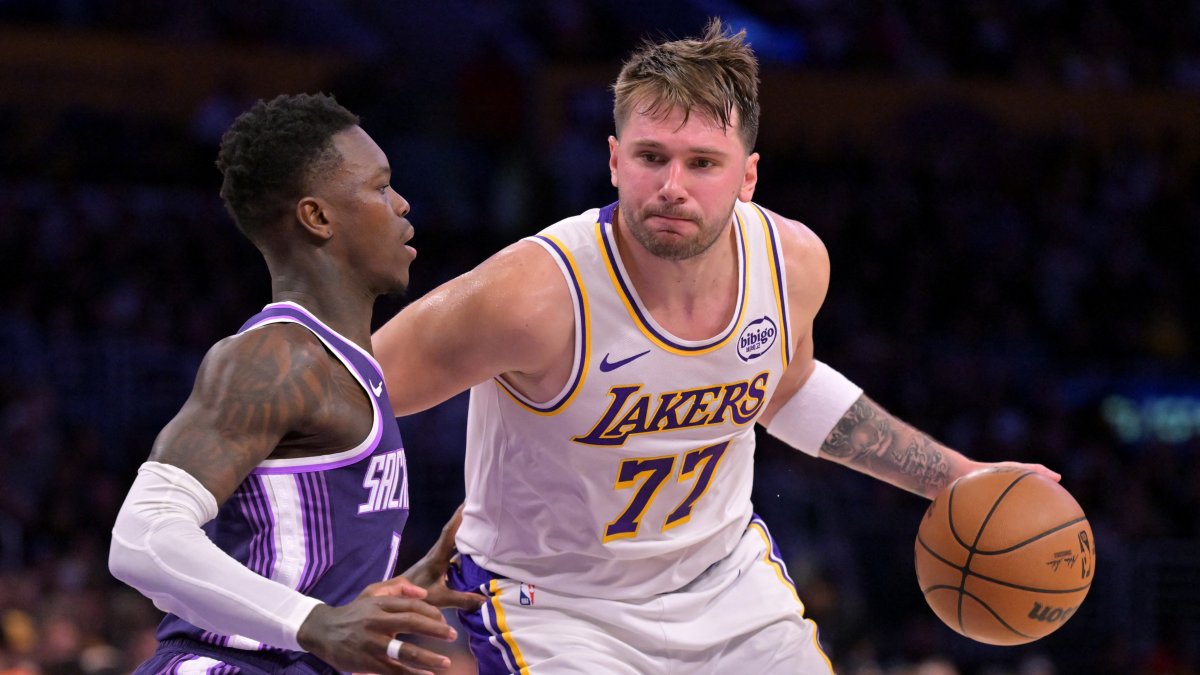 Sacramento Kings guard Dennis Schroder (L) defends Los Angeles Lakers guard Luka Doncic (77) during the NBA match at Crypto.com Arena, Los Angeles, U.S., Dec 28, 2025. (Reuters Photo)