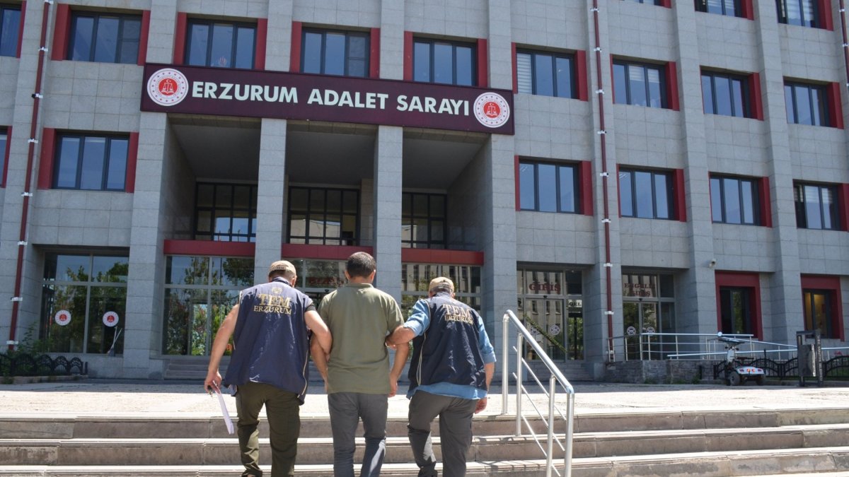 Two police officers escort a detained FETÖ suspect, Erzurum, eastern Türkiye, July 18, 2025. (AA Photo)