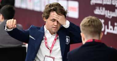 World champion and highest rancked chess player Norway's Magnus Carlsen (L) plays aginst Russia' Sarana Alexey during the 10th round of the FIDE World Rapid and Blitz Championships 2025 at the Sports and Events Complex, at Qatar University, Doha, Qatar, Dec. 28, 2025. (AFP Photo)