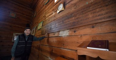 Village mukhtar Oğuzhan Şenel poses for a photo inside the nail-free Esederesi Mosque in Paşaköy, Kastamonu, northern Türkiye, Dec. 16, 2025. (AA Photo)