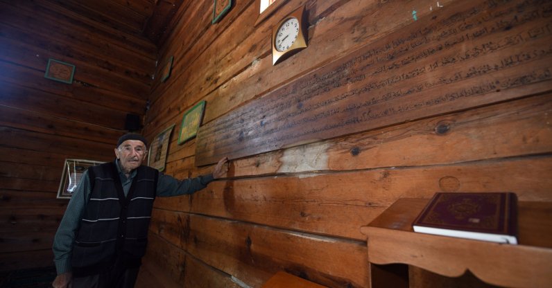 Village mukhtar Oğuzhan Şenel poses for a photo inside the nail-free Esederesi Mosque in Paşaköy, Kastamonu, northern Türkiye, Dec. 16, 2025. (AA Photo)