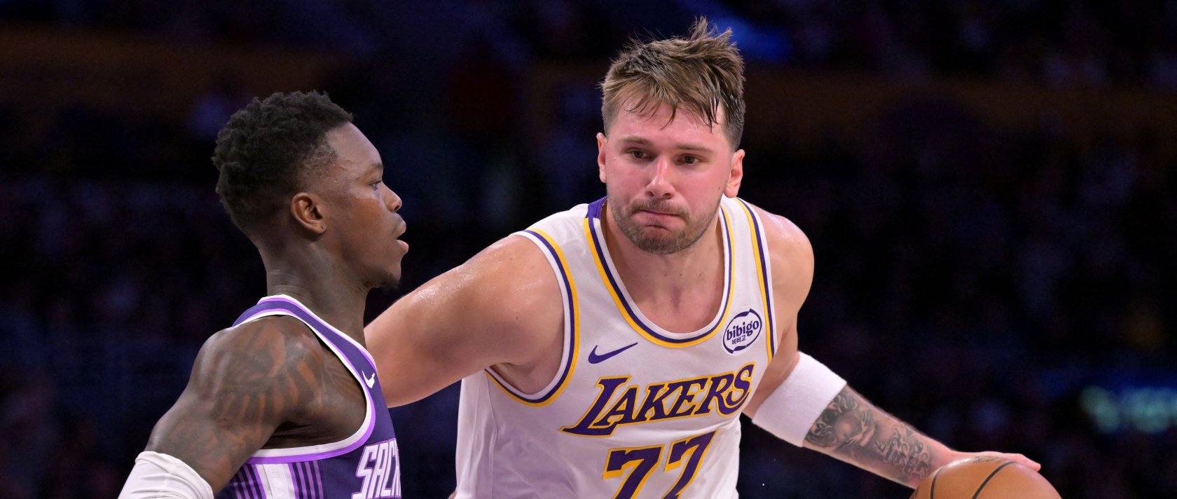 Sacramento Kings guard Dennis Schroder (L) defends Los Angeles Lakers guard Luka Doncic (77) during the NBA match at Crypto.com Arena, Los Angeles, U.S., Dec 28, 2025. (Reuters Photo)