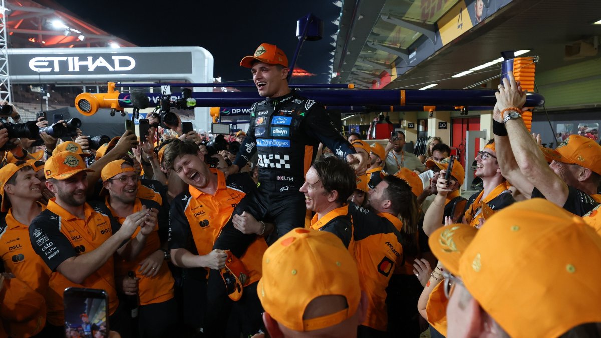 McLaren driver Lando Norris (C) is celebrated by team members for winning the 2025 Formula 1 drivers' world championship after the Formula One Abu Dhabi Grand Prix at the Yas Marina Circuit racetrack, Abu Dhabi, UAE, Dec. 7, 2025. (EPA Photo)