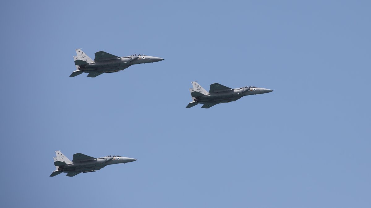 Israeli Air Force F-15 planes fly in formation over the Mediterranean Sea as seen from a Tel Aviv beach, Tel Aviv, Israel, April 15, 2021. (Reuters Photo)