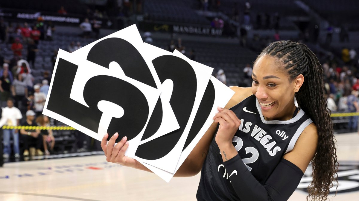 Las Vegas Aces center A'ja Wilson holds up numbers to commemorate her WNBA career 5,000 points after the Aces defeated the Connecticut Sun in a WNBA basketball game, Las Vegas, U.S., June 25, 2025. (AP Photo)