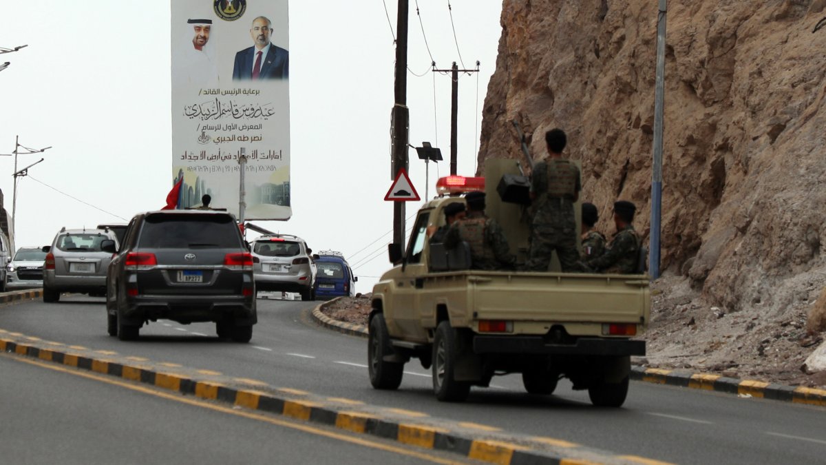 Southern forces ride a vehicle driving past a banner depicting UAE President Sheikh Mohammed bin Zayed Al Nahyan (L) and the top leader of the UAE-backed Southern Transitional Council (STC), Aidaros Alzubidi, in the southern port city of Aden, Yemen, Dec. 30, 2025. (EPA Photo)