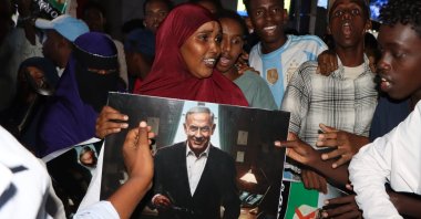 A woman holds a poster depicting Israeli Prime Minister Benjamin Netanyahu as demonstrators gather during an anti-Israel protest, Mogadishu, Somalia, Dec. 28, 2025. (EPA Photo)