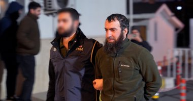 A police officer escorts a detained Daesh suspect, Istanbul, Türkiye, Dec. 30, 2025. (AA Photo)