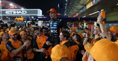 McLaren driver Lando Norris (C) is celebrated by team members for winning the 2025 Formula 1 drivers' world championship after the Formula One Abu Dhabi Grand Prix at the Yas Marina Circuit racetrack, Abu Dhabi, UAE, Dec. 7, 2025. (EPA Photo)