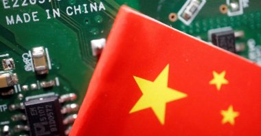 A Chinese flag is displayed next to a "Made in China" sign seen on a printed circuit board with semiconductor chips, in this illustration picture taken Feb. 17, 2023. (Reuters Photo)