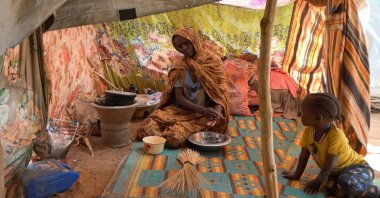 Awadeya, a Sudanese displaced woman who was held by the paramilitary Rapid Support Forces (RSF), cooks food at a camp for displaced people who fled from al-Fashir to Tawila, North Darfur, Sudan, Nov. 15, 2025. (Reuters File Photo)