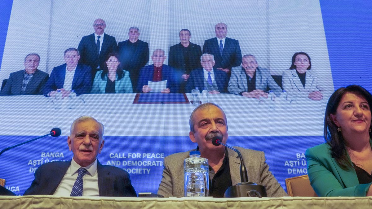 A delegation from the DEM Party announces the call of terrorist PKK leader Abdullah Öcalan (C in background photo) at a news conference,  Istanbul, Türkiye, Feb. 27, 2025. (AP Photo)
