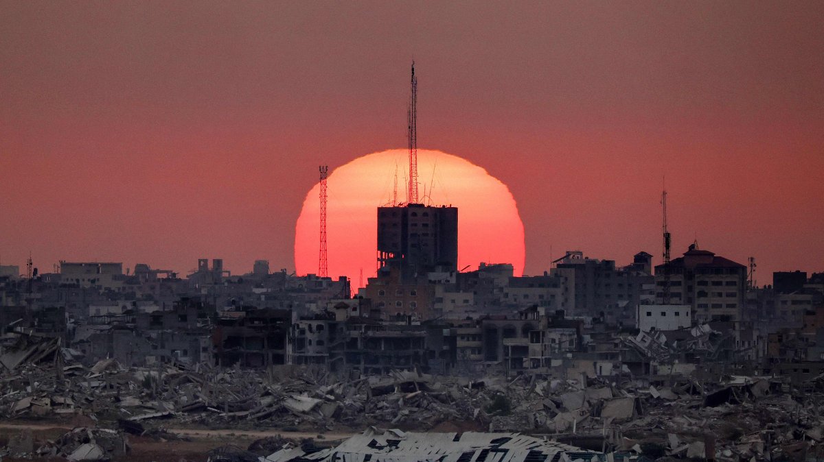 The sun sets behind destroyed buildings in the Gaza Strip, Israel-Palestine border, July 1, 2025. (AFP Photo)