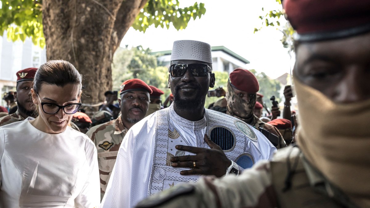 Guinea President and presidential candidate Mamady Doumbouya (C) and his wife Lauriane Doumbouya arrive to vote at a polling station in Conakry, Guinea, Dec. 28, 2025. (AFP Photo)