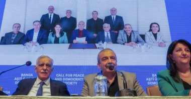 A delegation from the DEM Party announces the call of terrorist PKK leader Abdullah Öcalan (C in background photo) at a news conference,  Istanbul, Türkiye, Feb. 27, 2025. (AP Photo)