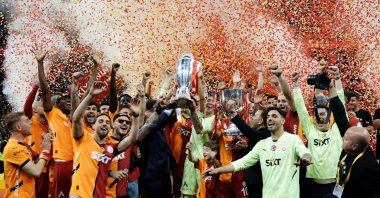 Galatasaray players celebrate on the pitch after clinching both the Süper Lig and Ziraat Türkiye Cup trophies during the championship ceremony, Istanbul, Türkiye, May 25, 2025. (IHA Photo)