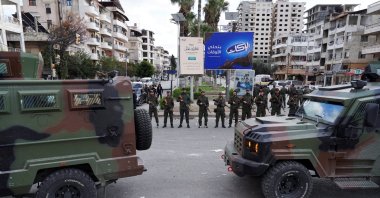 Members of the Syrian Security forces stand guard near military vehicles in Latakia, Syria, Dec. 28, 2025. (Reuters File Photo)