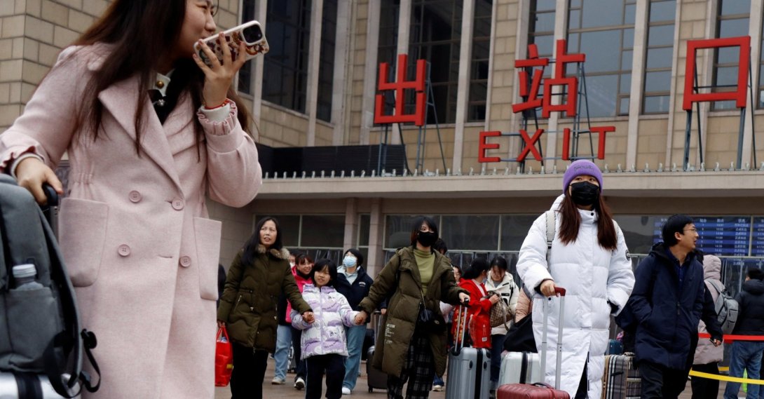 Travelers walk with their luggage outside the Beijing railway station during the Spring Festival travel rush following the Lunar New Year holiday, Beijing, China, Feb. 18, 2024. (Reuters File Photo)