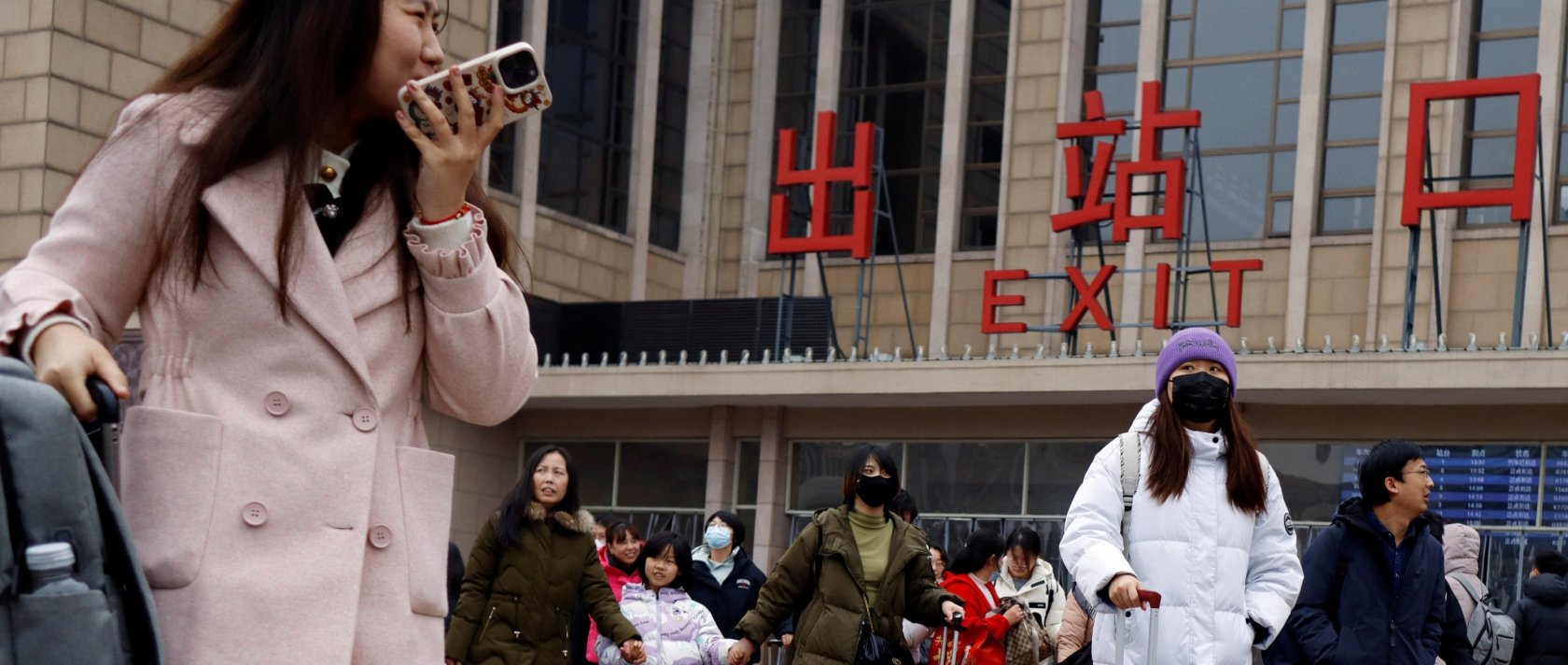 Travelers walk with their luggage outside the Beijing railway station during the Spring Festival travel rush following the Lunar New Year holiday, Beijing, China, Feb. 18, 2024. (Reuters File Photo)