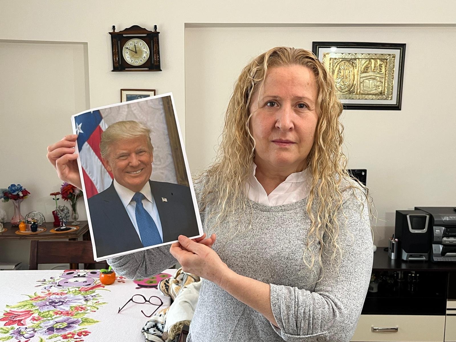 Necla Özmen poses with a photo of U.S. President Donald Trump during an interview with DHA at her home in the capital Ankara, Türkiye, Dec. 31, 2025. (DHA Photo)