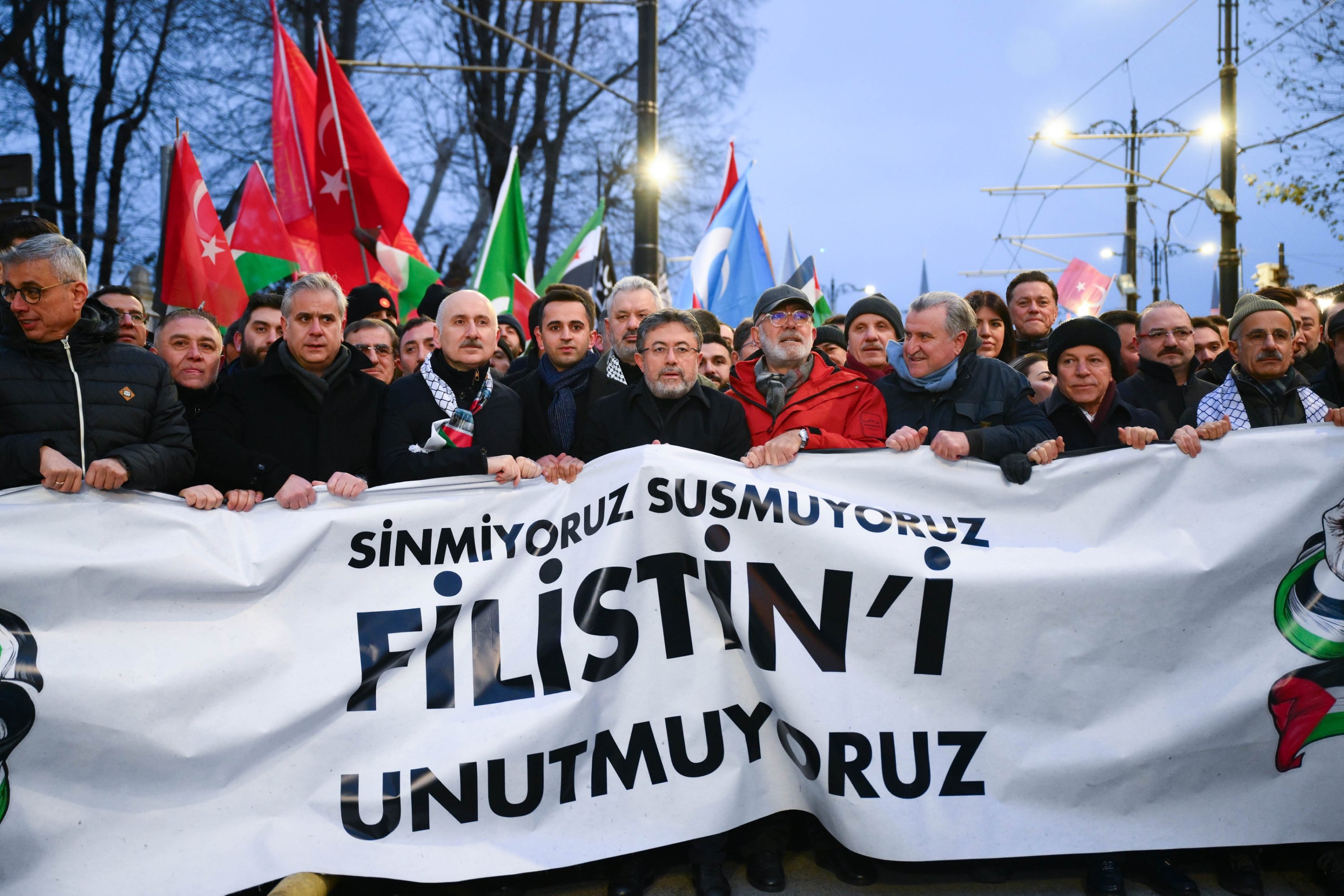 Ministers and AK Party officials carry a banner reading 