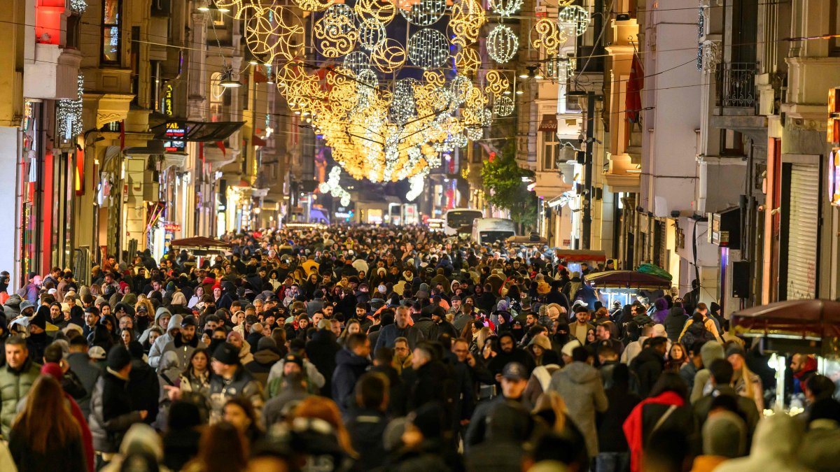Pedestrians walk along Istiklal Street decorated with light ornaments, Istanbul, Türkiye, Dec. 31, 2025. (AFP Photo)
